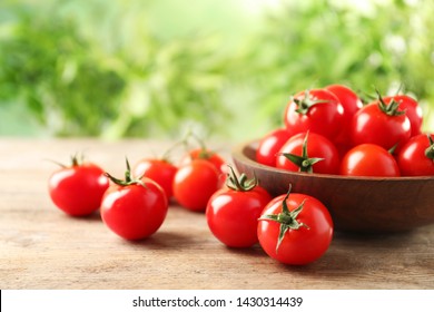 Bowl of fresh cherry tomatoes on wooden table - Powered by Shutterstock