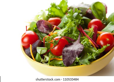 Bowl of fresh crisp green salad with tomatoes and carrots for healthy eating and low calorie dieting