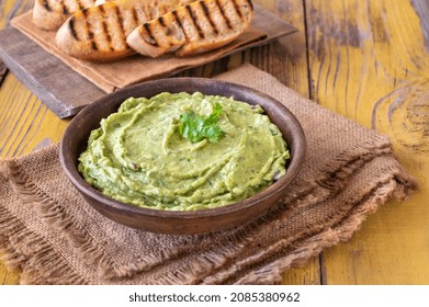 Bowl Of Fresh Guacamole On Rustic Background