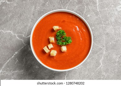 Bowl With Fresh Homemade Tomato Soup On Grey Background, Top View