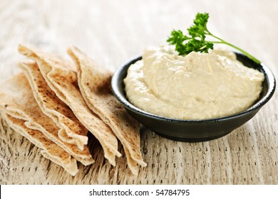 Bowl Of Fresh Hummus Dip With Pita Bread Slices