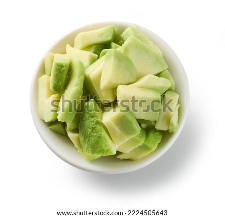 bowl of fresh raw avocado pieces isolated on white background, top view