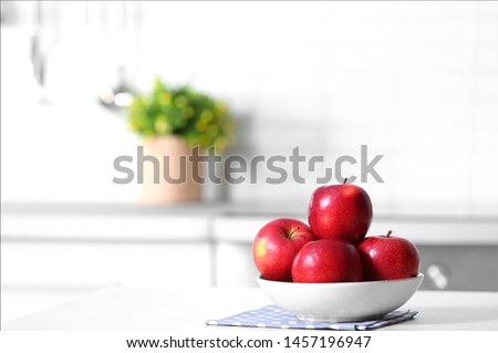 Bowl of fresh red apples on kitchen counter. Space for text