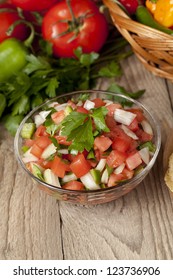 Bowl Of Fresh Salsa On Wooden Table