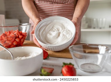 Bowl with fresh whipped egg white holding by woman´s hand - Powered by Shutterstock