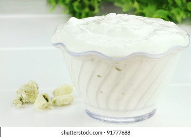 Bowl Of Freshly Made Blue Cheese Salad Dressing With Fresh Lettuce In Background.