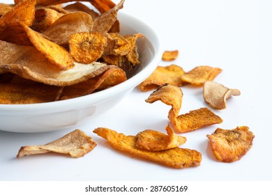 Bowl Of Fried Carrot And Parsnip Chips. On White.