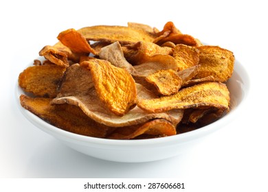 Bowl Of Fried Carrot And Parsnip Chips. Isolated.