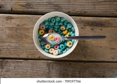 Bowl Of Froot Loops With Spoon On Wooden Table