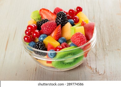 Bowl Of Fruit Salad Isolated On Wood Table