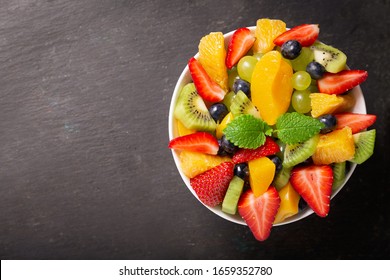 Bowl Of Fruit Salad On A Dark Backgorund, Top View