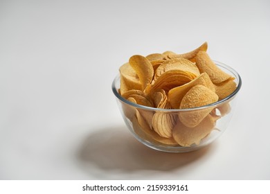 Bowl Full Of Delicious And Appetizing Heap Of Potato Chips. Unhealthy Eating And Junk Food. Crispy Snack For Takeaway And Leisure. Isolated On White Background. Studio Shoot. Copy Space