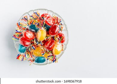 Bowl full with mix hard wrapped candies isolated on white background. Space for text - Powered by Shutterstock