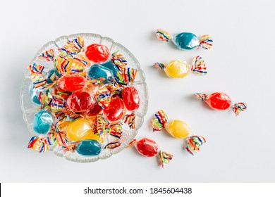 Bowl full with mix hard wrapped candies isolated on white background. - Powered by Shutterstock