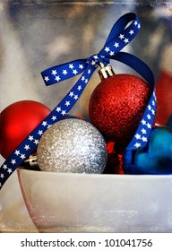 Bowl Full Of Red White &blue Christmas Ornaments With An Old Flag Background For A Patriotic Christmas Theme - Aged With A Texture