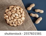 Bowl full of shelled and roasted peeled peanuts,top view