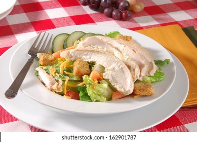 A Bowl Of Garden Salad With Chicken Strips