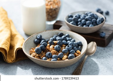 Bowl of granola with blueberries and bottle of milk. Healthy breakfast food - Shutterstock ID 1789239413