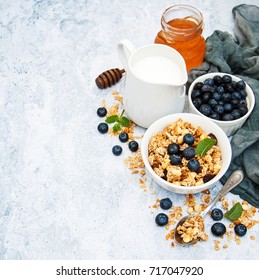Bowl with granola and blueberries on a table