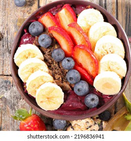 Açaí Bowl With Granola, Tropical Fruits, Banana, Raspberry, Condensed Milk And Cereal. Selective Focus. Close Up.
