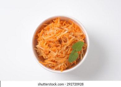 Bowl Of Grated Carrot On White Background