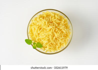 Bowl Of Grated Cheese On White Background