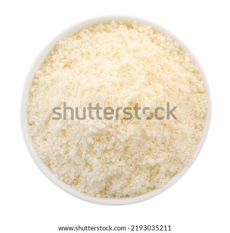 Bowl with grated parmesan cheese isolated on white, top view