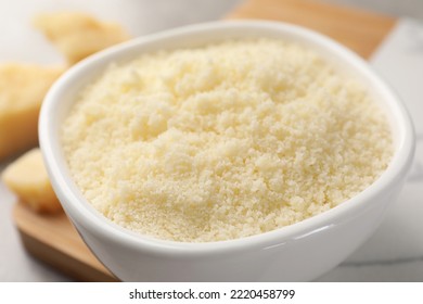 Bowl With Grated Parmesan Cheese On Table, Closeup