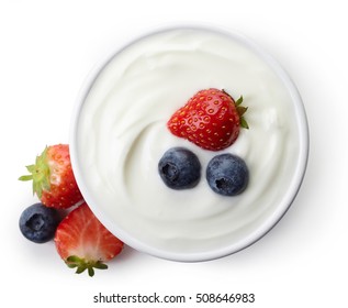 Bowl of greek yogurt and fresh berries isolated on white background from top view