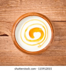 A bowl of greek yogurt with honey