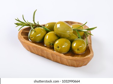 bowl of green olives with rosemary on white background - Powered by Shutterstock