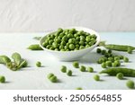 Bowl of green peas on light table