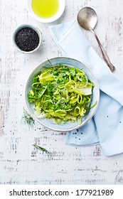 Bowl Of Green Salad Made With Romaine Lettuce, Leek, Fresh Dill And Sesame Seeds. Home Made Food. Concept For A Tasty And Healthy Meal. White Wooden Background. Top View. Copy Space.