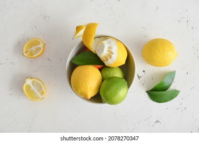 Bowl With Healthy Citrus Fruits On Light Background