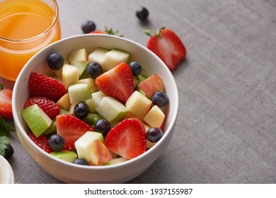 Bowl Of Healthy Fresh Fruit Salad. Fresh Fruit And Vegetable Salad, Healthy Breakfast. Bowl Of Oat Granola With Yogurt. Orange Juice Drink.