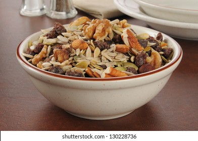 A Bowl Of Healthy Trail Mix With Raisins, Pecans, Walnuts, Almonds And Sunflower Seeds