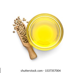 Bowl With Hemp Oil And Seeds On White Background, Top View