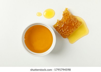 Bowl With Honey And Honeycomb On White Background