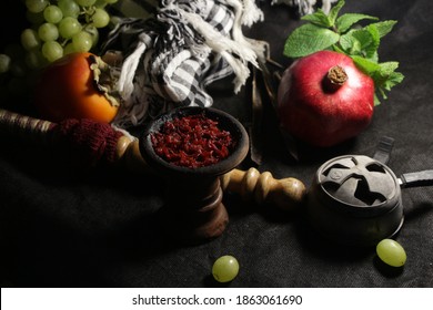 bowl of hookah tobacco. berries on a black background. sheesha smoking