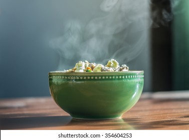 Bowl Of Hot Food With Steam On Dark Background. Toned Image.soft Focus