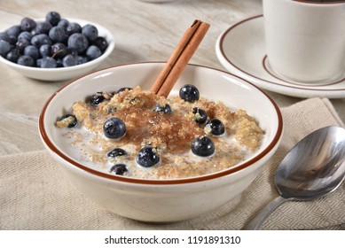 A Bowl Of Hot Quinoa Breakfast Cereal With Brown Sugar, Cinnamon And Blueberries