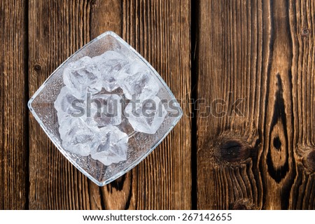 Bowl with Ice Cubes (on dark wooden background)