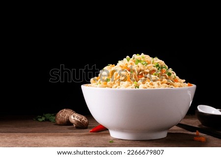 bowl of instant noodles or pasta. Delicious hot soup. Thai, Chinese, and Japanese food arranged on table isolated on black background.
