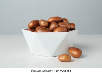 Bowl of jackfruit seeds on white wooden table