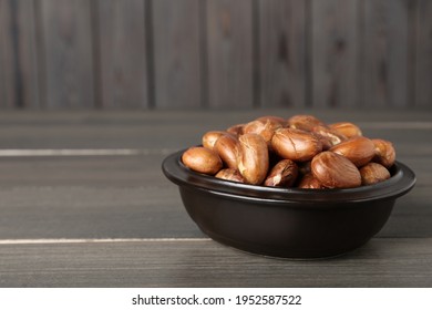 Bowl of jackfruit seeds on wooden table. Space for text
