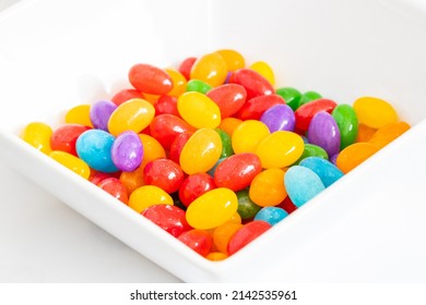 A Bowl Of Jelly Beans On A White Background.