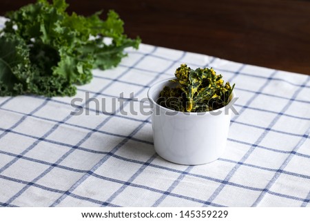 bowl of kale chips on kitchen towel