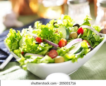 Bowl Of Leafy Green Salad With Olives, Tomatoes And Cucumber.