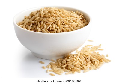 Bowl Of Long Grain Brown Rice Isolated On White. Spilled Rice.