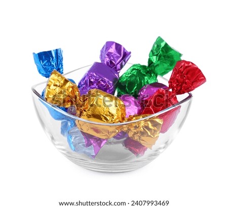 Bowl with many tasty candies in colorful wrappers isolated on white
